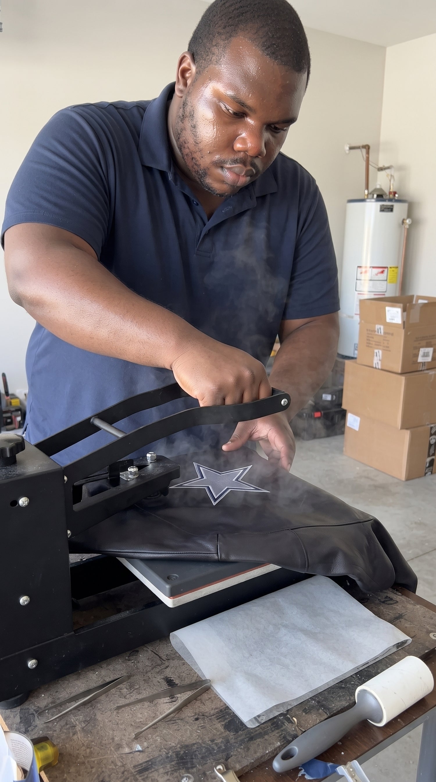 Larry heat pressing a team patch onto a leather jacket